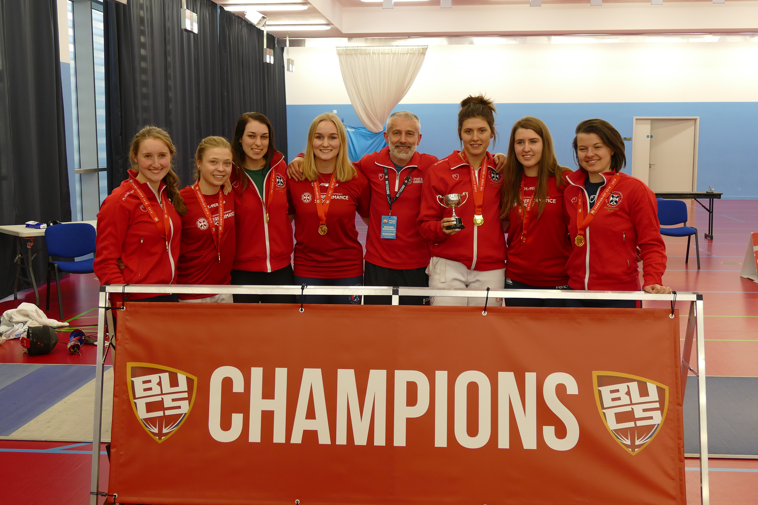 Fencers behind Champion Banner